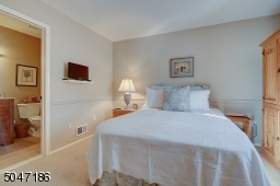 en suite bedroom and California closet system in closet.