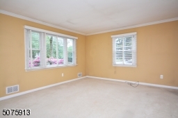 Living room is a nice size with hardwood under the carpet