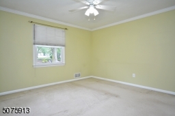 First floor bedroom with hardwood under the carpet