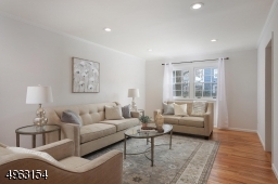 Sunlit living room with newly refinished floors, rec. lighting, insulated windows