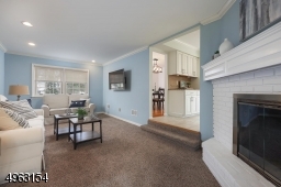 Right off the kitchen and dining room for modern living.  Wood burning fireplace with brick surround, custom cherry mantel