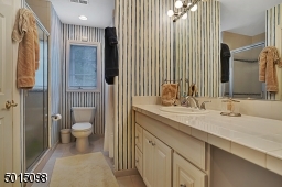Here's a full bath which directly adjoins one of the ancillary bedrooms.