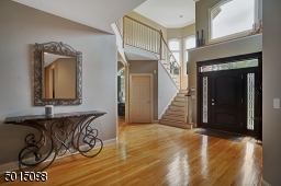 The 2-story entrance foyer is bright and spacious allowing one to gain a sense of  the openness and volume of the expansive first level.