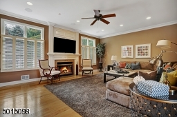 The family room is invitingly wide and deep enabling a variety of soft-seating configurations. A flush hearth fireplace, oversized windows and a TV set-up featuring 'surround sound' all make for a extremely comfortable gathering space.