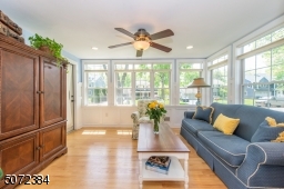 Two walls of windows, ceiling fan, & access to front porch