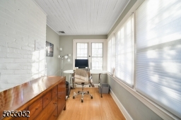 Hardwood floors in this flood sunlit den or office.