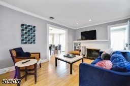 Chic grey walls and gleaming hardwood floors throughout. Oversized Formal Living Room has a gorgeous white brick wood burning fireplace.
