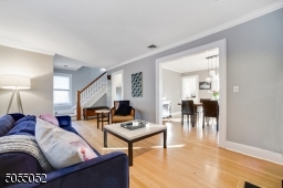 Painted soothing grey hues with gleaming hardwood floors, gracious floor plan and flow. Oversized Living Room opens to Formal Dining Room and private Home Office.