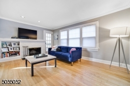 Chic grey walls and gleaming hardwood floors throughout. Oversized Formal Living Room has a gorgeous white brick wood burning fireplace.