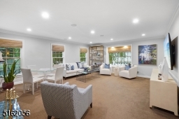 Family RM w/ wall to wall carpeting & HWD floors underneath, recessed lights, built-in speakers, crown moldings, fireplace w/ wood mantel & marble hearth, 2 exposures of windows & 2 French doors which lead to another the Game Room/ Leisure Room