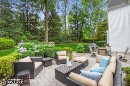 Fully fenced rear yard with mature plantings and a large paver patio with access to the Kitchen and Family Room