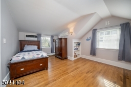 Second Floor Bedroom with multiple windows, hardwoods and built in storage.