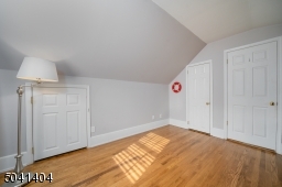 Second Floor Bedroom with multiple windows, hardwoods and built in storage.