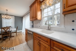 Kitchen view into adjacent dining room with Sliders to deck and back yard.