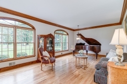 Grand room with custom moldings,hard wood floor and floor to ceiling windows