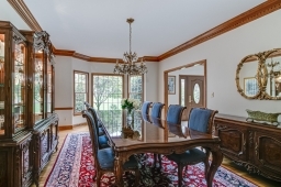 Grand room with custom moldings, hard wood floor and bay window