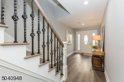 Custom decorative  railing with baluster and baskets.   Wide plank flooring