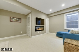in finished basement with electric fireplace.