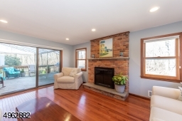 With wood burning fireplace and sliders to the deck and yard