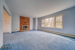 Light filled living room with wood burning fireplace