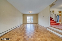 First floor family room with sliders to deck and backyard; garage entrance