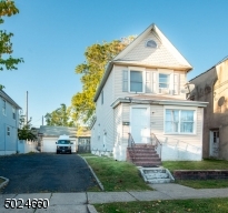 Large Driveway with 3 car garage, one used for storage.