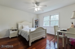 bedroom with wood floors, closet