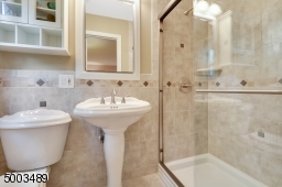 stall shower w/ ceramic tiles
