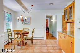 Tons of  counter space and overhead cabinets with glass doors offer a convenient prep space for entertaining. This wall can be easily opened to make a greater connection between rooms!