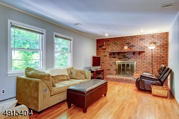 Gas Fireplace with Brick Hearth,newly refinished wood floors and accent recessed lighting on dimmer switches.