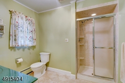 Stall Shower and Vanity with Space for a soaking tub or linen closet to be added.