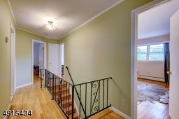 I love these iron railings that exemplify the integrity of this well built home with a second floor foyer complete with linen closet and full main bath