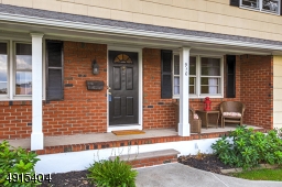 Covered porch entrance  welcomes guests and offers plenty of space to lounge with neighbors and friends!