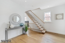 The focal point of the first floor is the open riser staircase with 4 inch thick oak treads. Stairs and metal railings were custom designed by renowned local stair craftsman.
