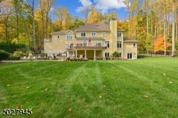Secluded quietude on lushly landscaped 1.4 acres, 7 drywells in rear yard,