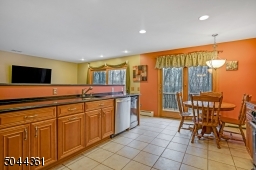 Large open kitchen, complete with SS appliances and a wine refrigerator.