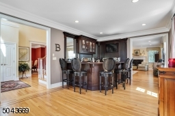 Spacious living room with spectacular mahogany bar. Perfect for entertaining
