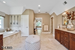 Spa-like Master Bathroom with jetted tub, steam shower and heated flooring.