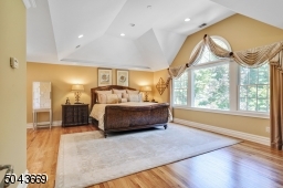 Light-filled Master Bedroom with vaulted ceiling and windows overlooking the backyard.