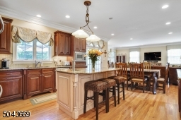 Large Kitchen open to eating area and family room with doors leading to deck.
