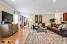 Family room with wood burning fireplace open to kitchen with doors to deck. Great flow for entertaining.