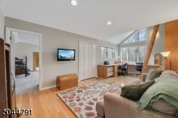 Sun-filled office/ /library has plenty of built-in desk space, floor to ceiling bookcase and a library ladder to get to the top shelves! Room enough for a couch and TV!