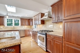 Granite counters, tile backsplash, stainless steel appliances, under cabinet lighting.