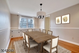 Formal Dining Room features custom built in cabinetry and encompassing chair rail.