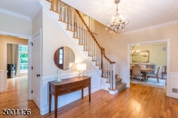 This elegant entryway is flanked by a Dining Room on one side and formal living room with transom windows and a gas fireplace on the other side