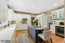 Custom cabinetry combined with nautical blue island shows timeless design. Perfect coffee/cocktail bar area.