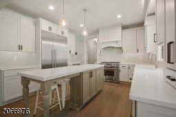 Chef's EIK featuring, Smart, Thermador SS appliances including a six-burner stove, built-in microwave, dishwasher, quartz countertops, Medallion custom wood cabinetry, hardwood floors, chevron grey tile backsplash