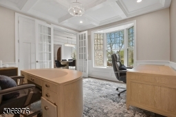 The private Home Office with double French privacy doors and coffered ceiling is the perfect spot for Zoom calls and extra study space.