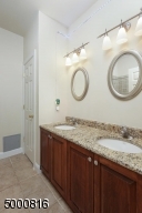 Two sinks, shower over bathtub and separate linen closet