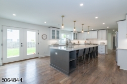 Kitchen is huge a real WOW with doors to patio. Island has seating for 4 stools/chairs on island. Note the "carrera marble" quartz counters